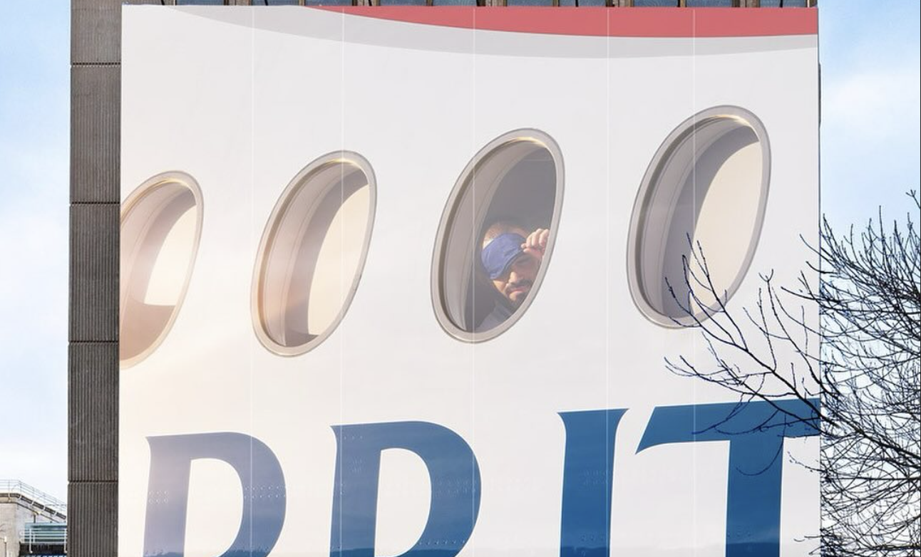 man lookingout of airplane