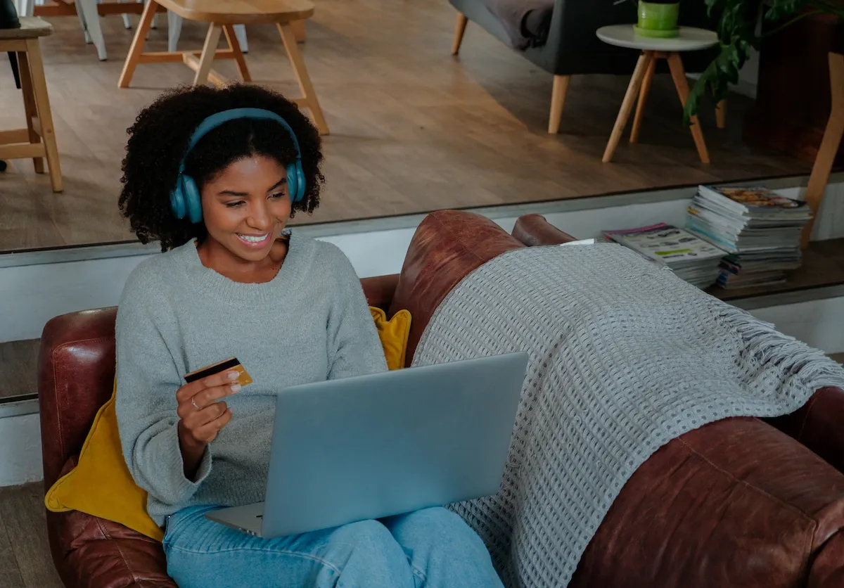 Woman on sofa at home shopping online